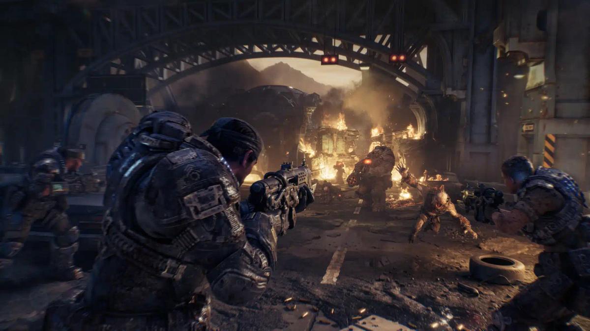 Gears of War: E-Day oyunundan, harabeye dönmüş bir şehir ortamında canavarlarla savaşan ağır zırhlı askerler.