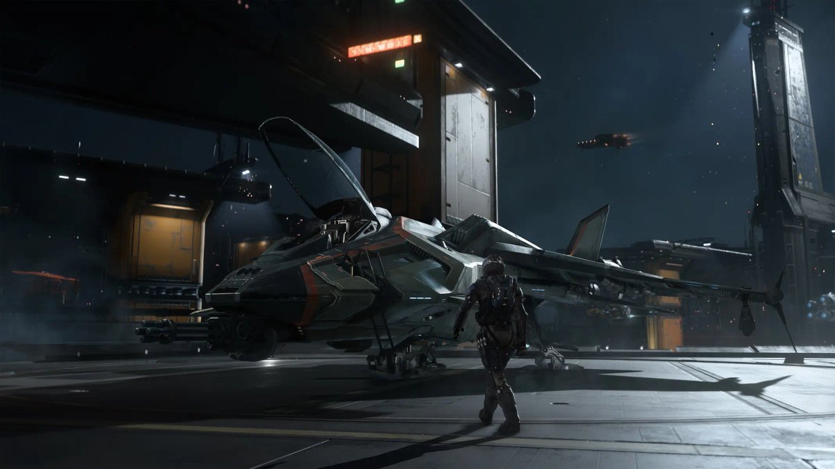A pilot standing next to a sleek, grey starfighter on a futuristic space station hangar deck in Squadron 42.